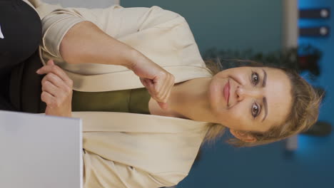 Vertical-video-of-Home-office-worker-woman-talking-motivationally-to-camera.